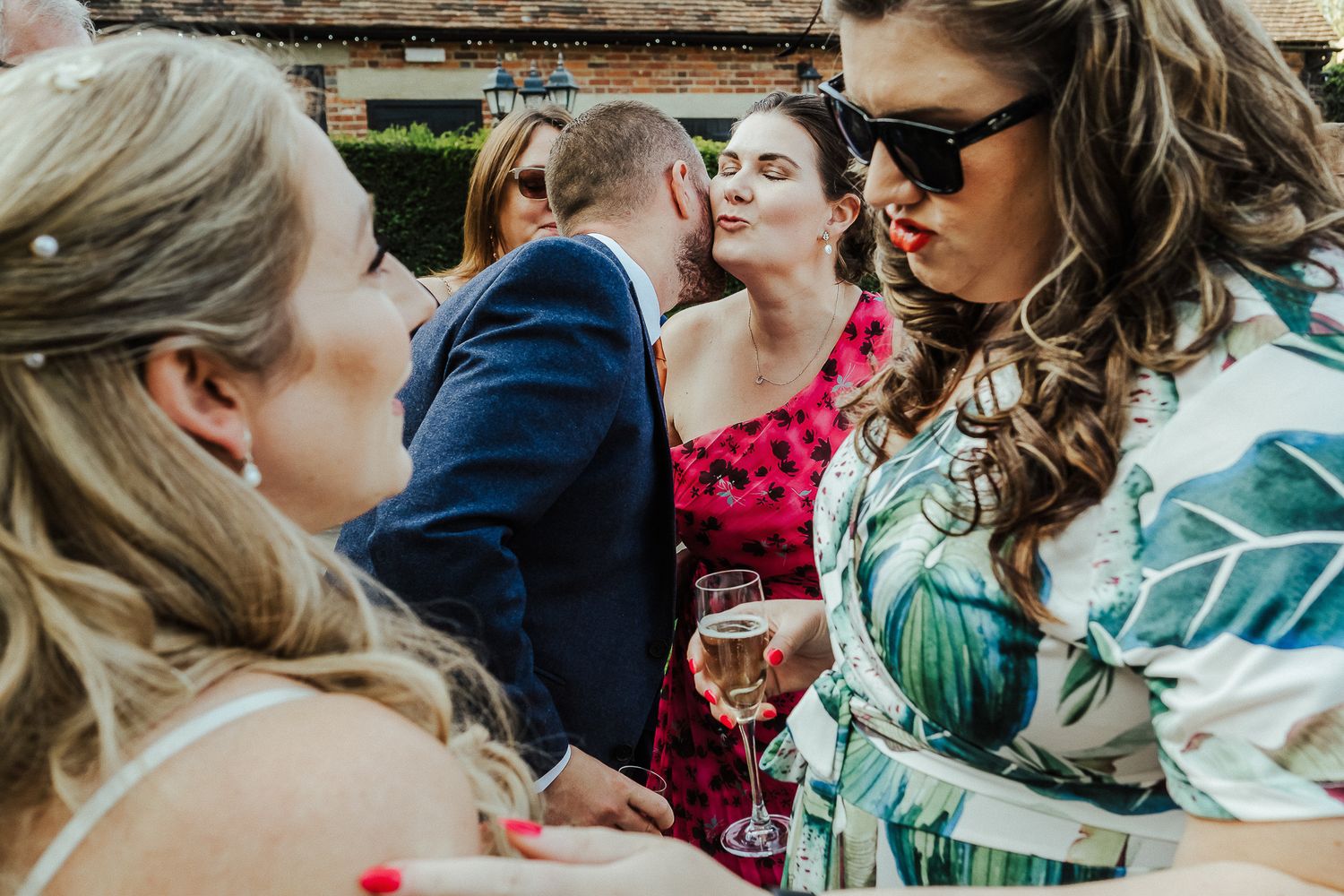 Candid moments of wedding guests laughing and socializing during outdoor celebration.