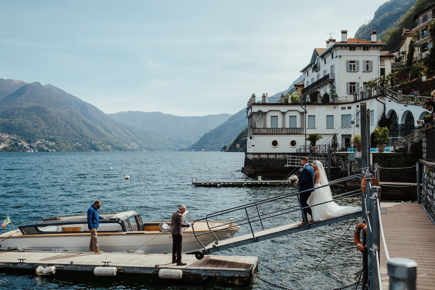 Scenic Lake Como wedding venue with mountains and historic architecture in background.
