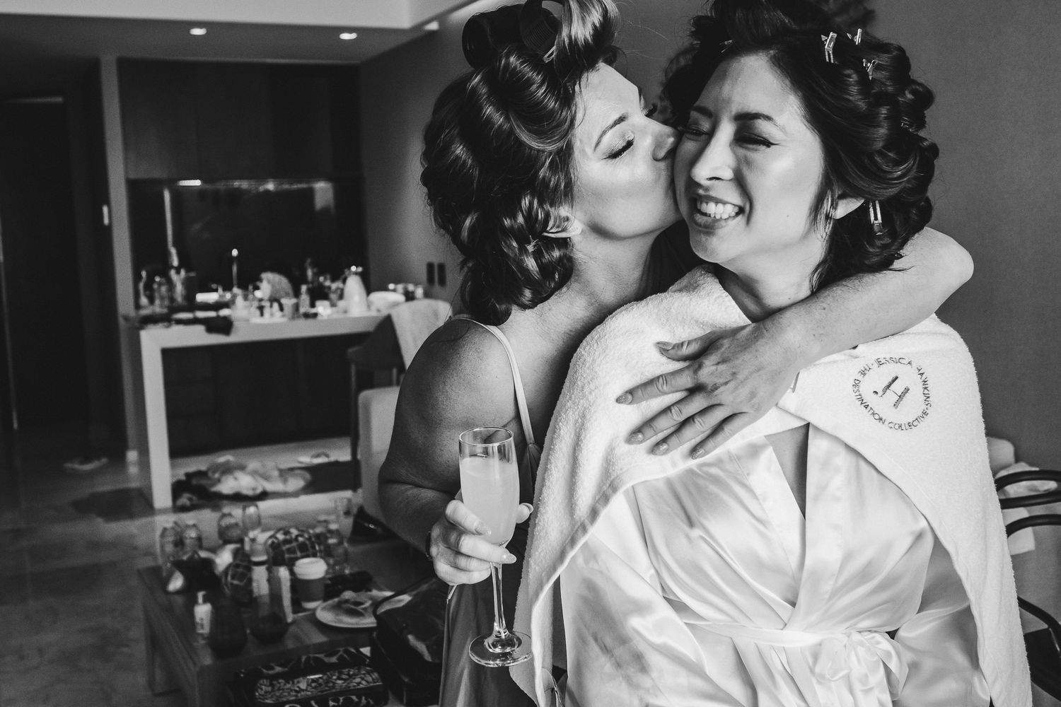 Two people sharing an intimate moment in black and white photography.
