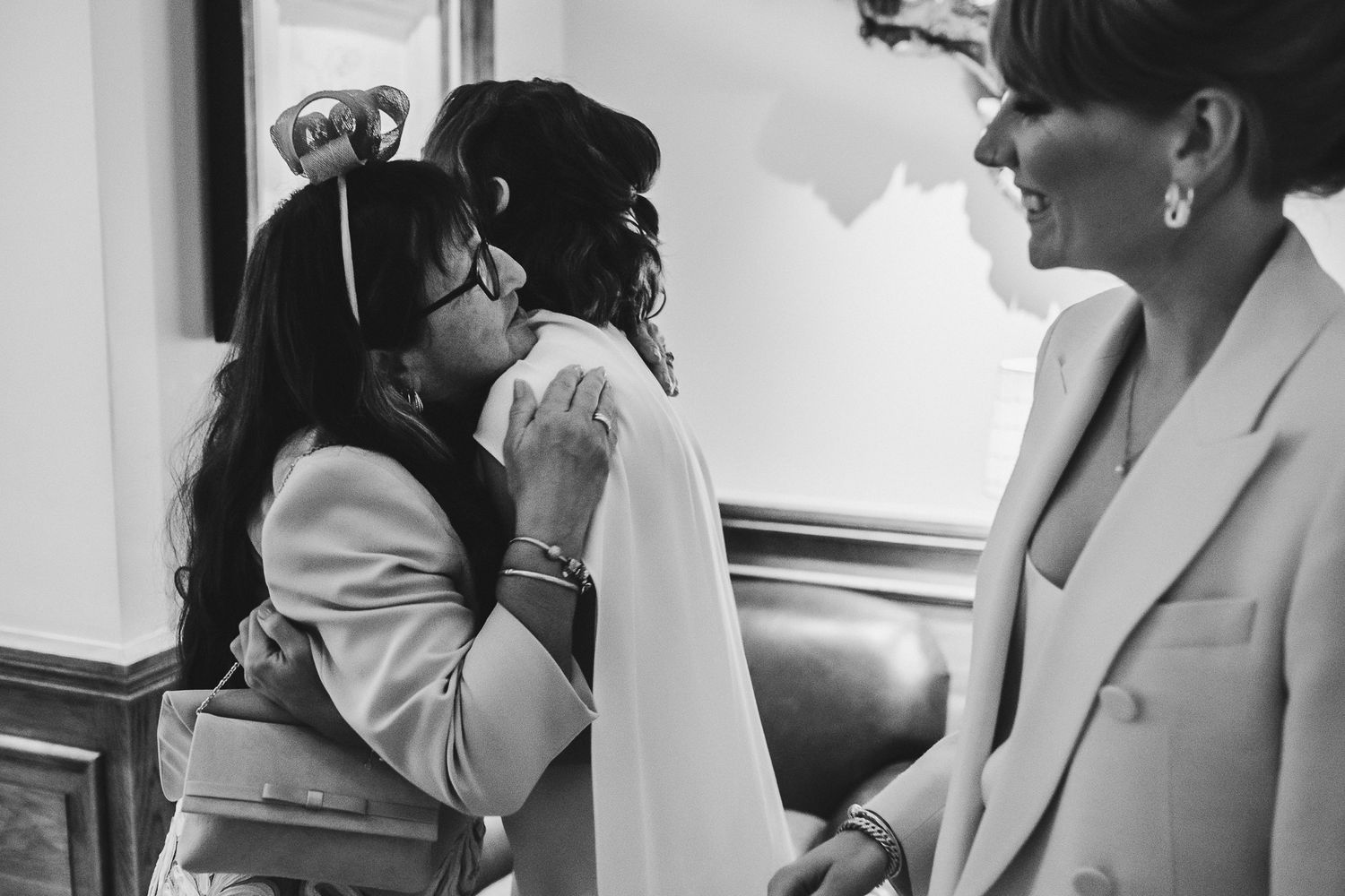 Black and white photo of intimate wedding preparation moment.