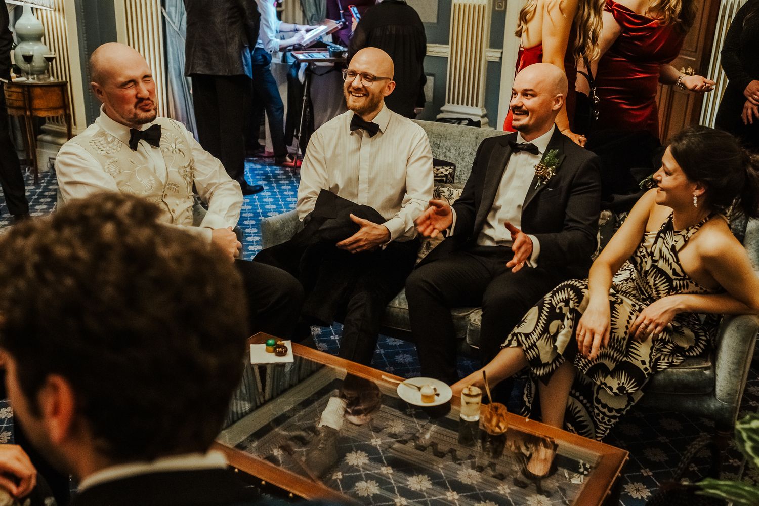 Guests enjoying drinks and conversation at an elegant evening wedding reception.