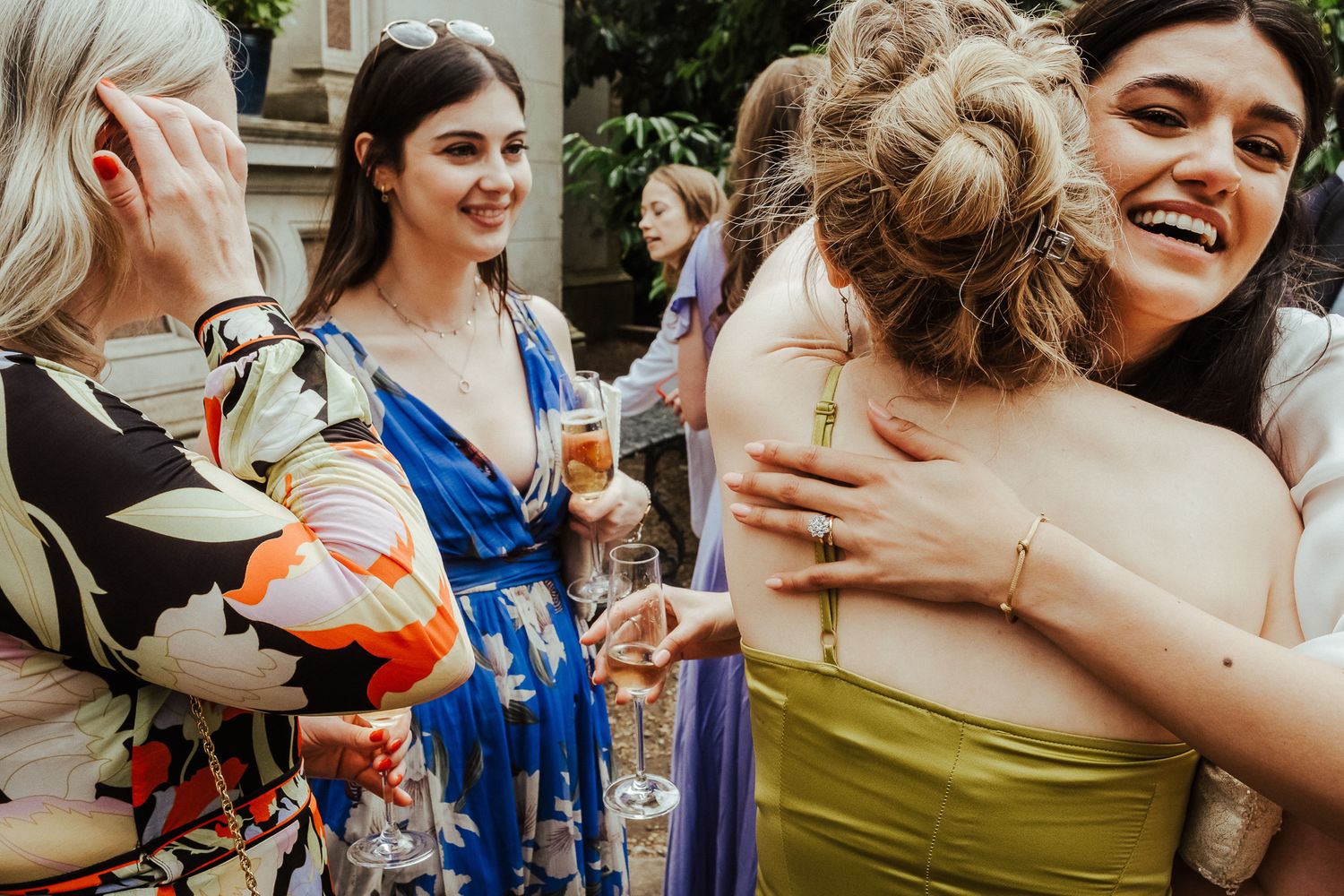 Wedding guests share joyful moments during an outdoor celebration.