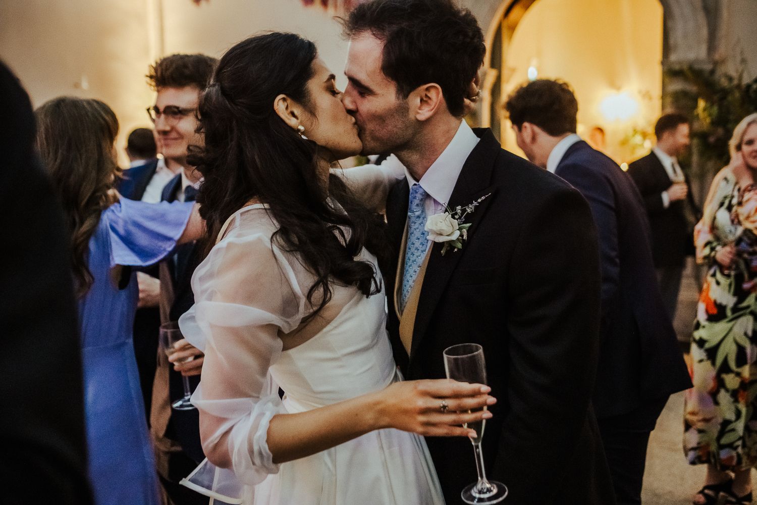 Romantic moment captured between newlyweds at an elegant indoor reception.