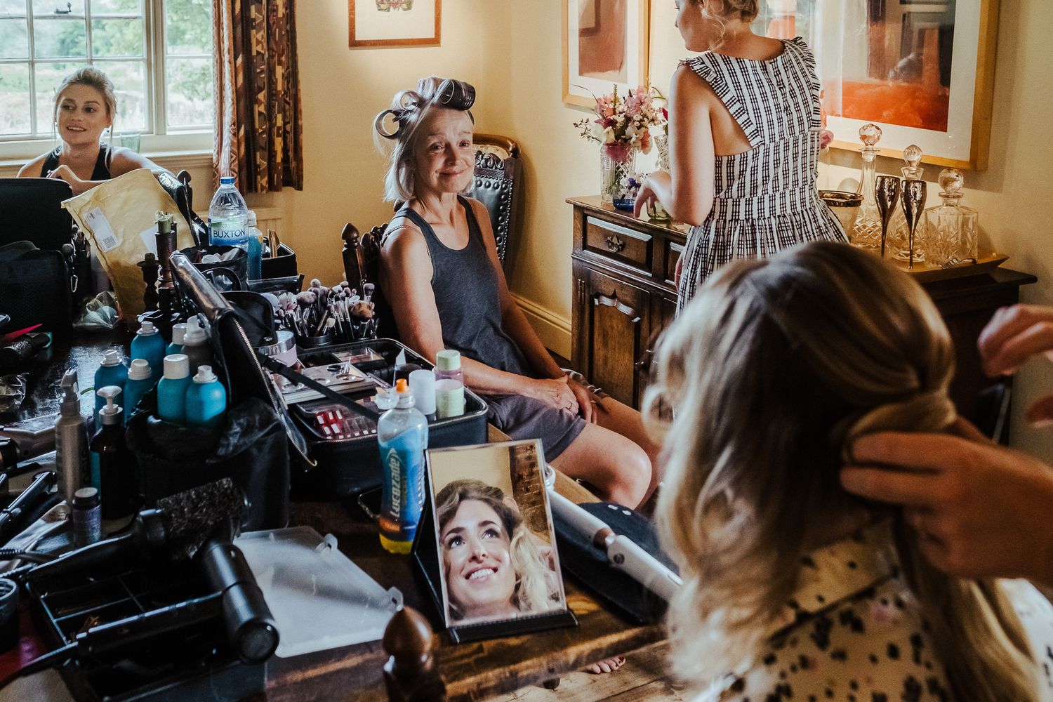 Casual moments of wedding preparations and laughter shared in a warmly lit room.