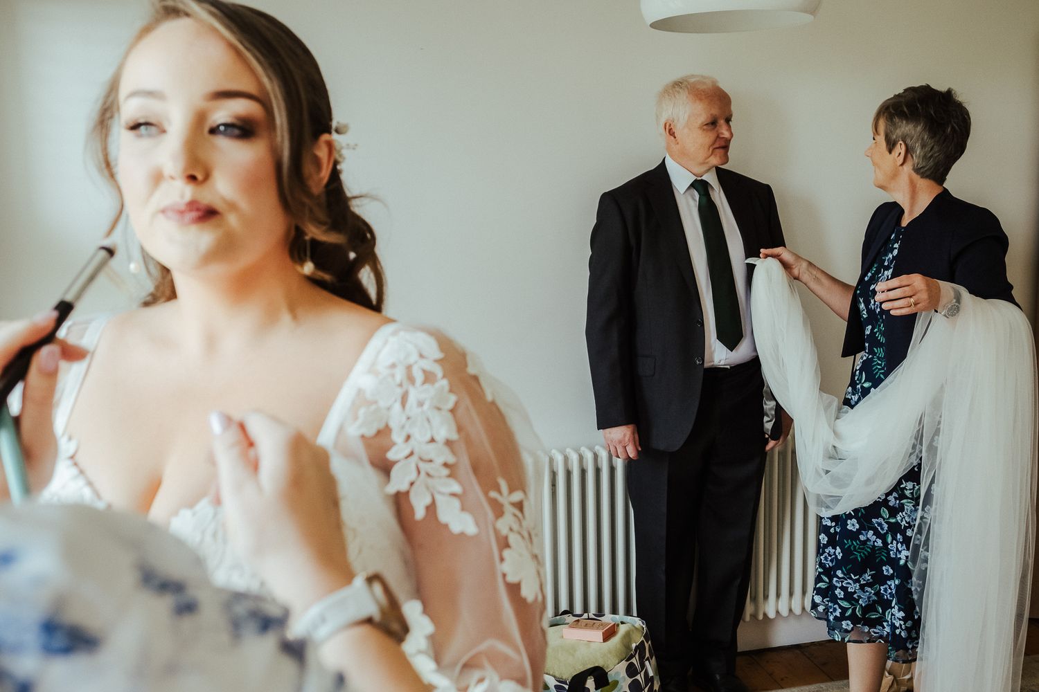 Getting ready scene in a bright room with formal wear and preparations.