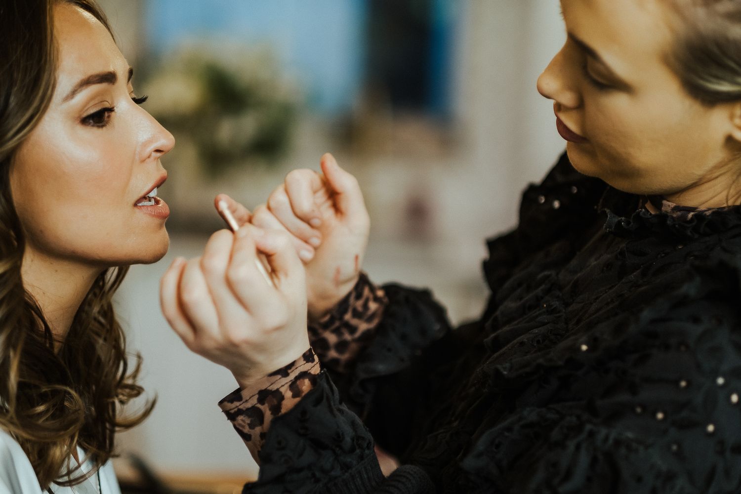 A group of bridesmaids share joyful moments and laughter at a wedding celebration.