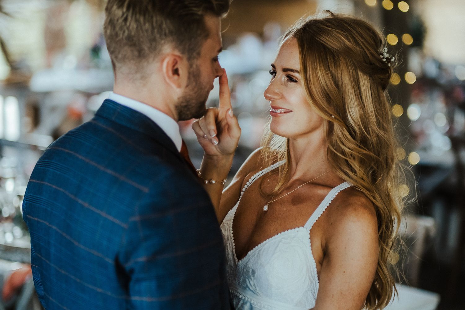 An intimate wedding moment captured with soft lighting and bokeh background.