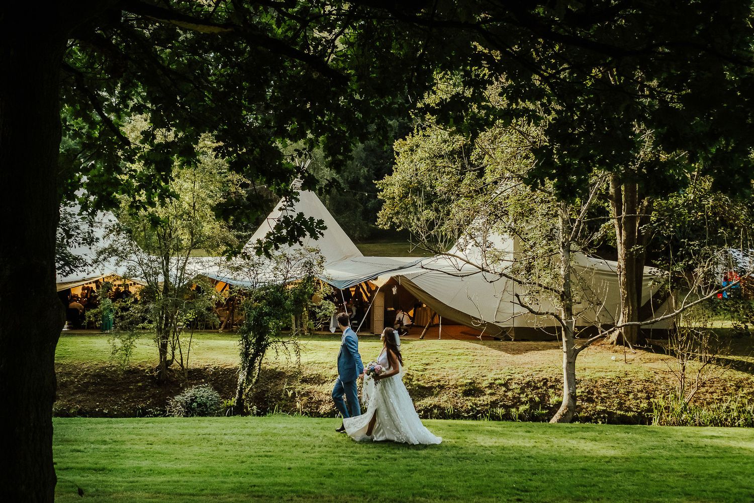 A series of wedding photos showing a teepee setup in a scenic outdoor venue with sprawling green lawns.