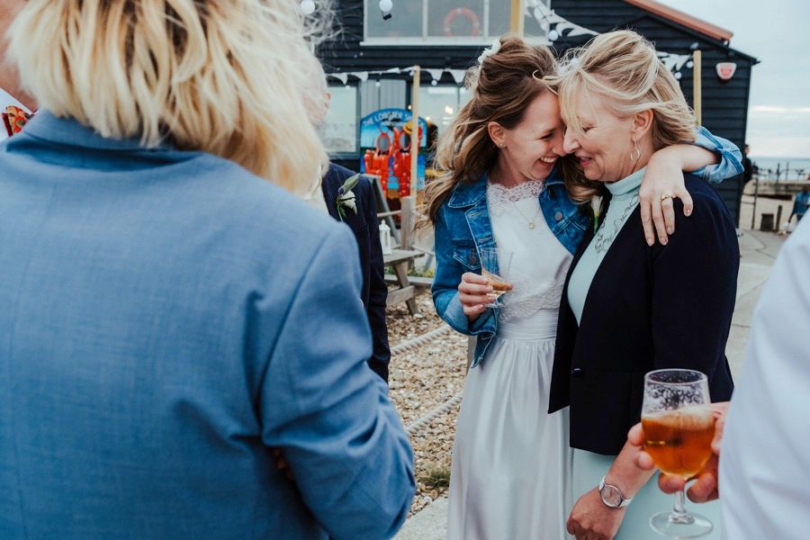 Wedding guests sharing an intimate moment during outdoor cocktail reception.