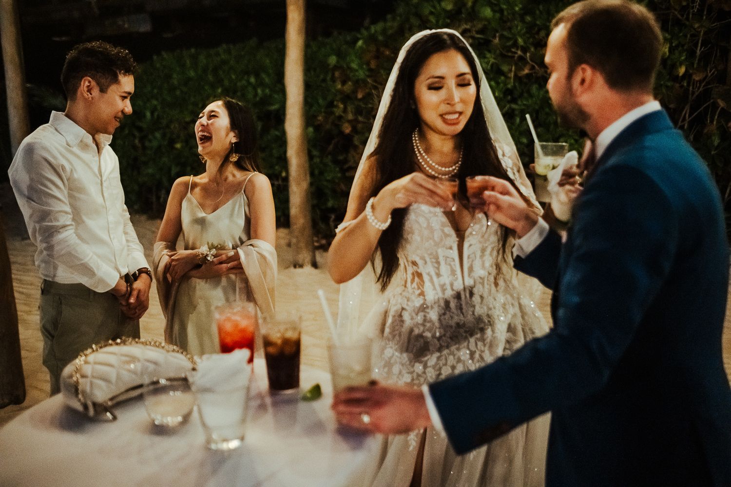 Wedding guests engaged in lively conversation at an outdoor reception.