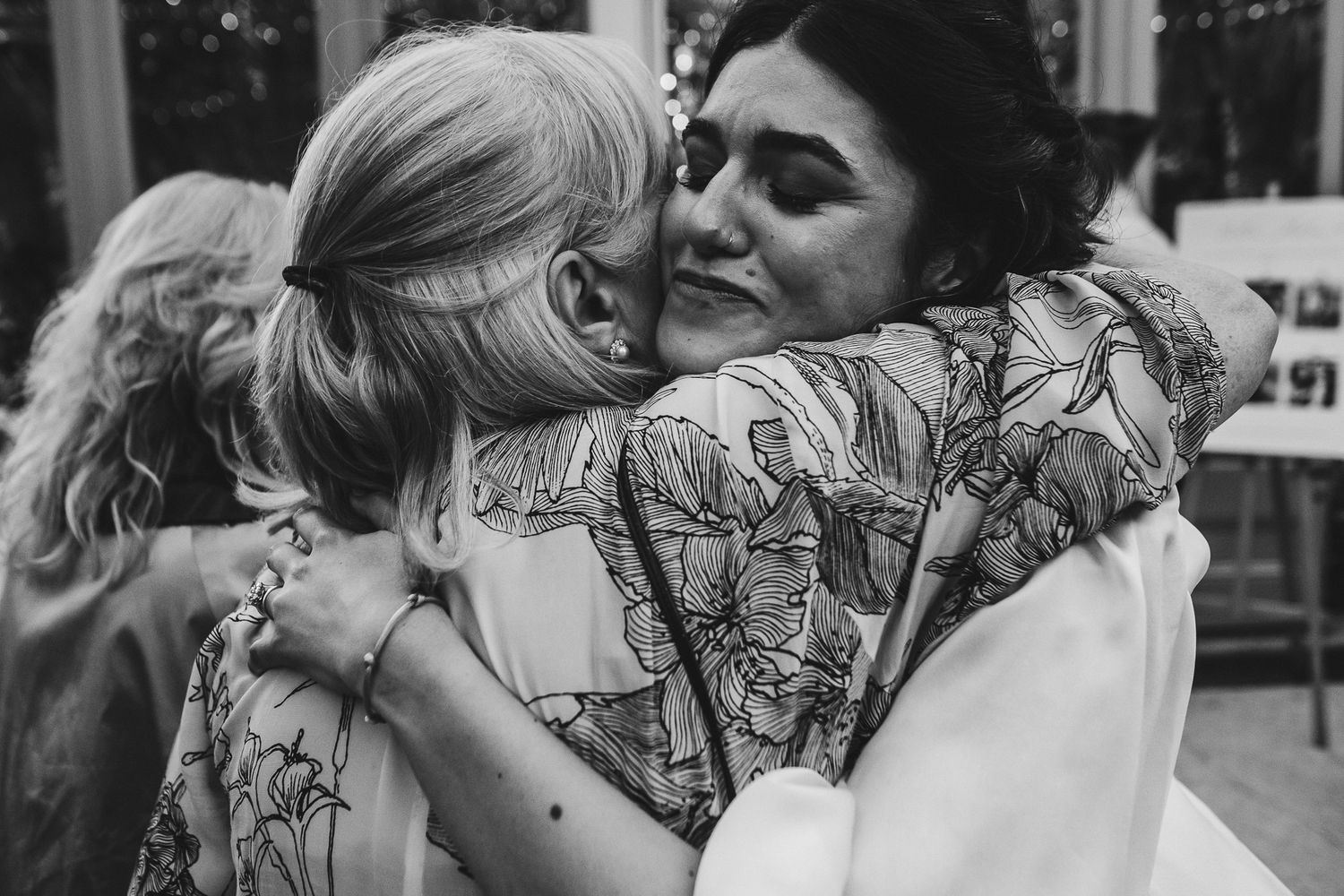 Intimate moments captured between guests at an outdoor wedding reception.