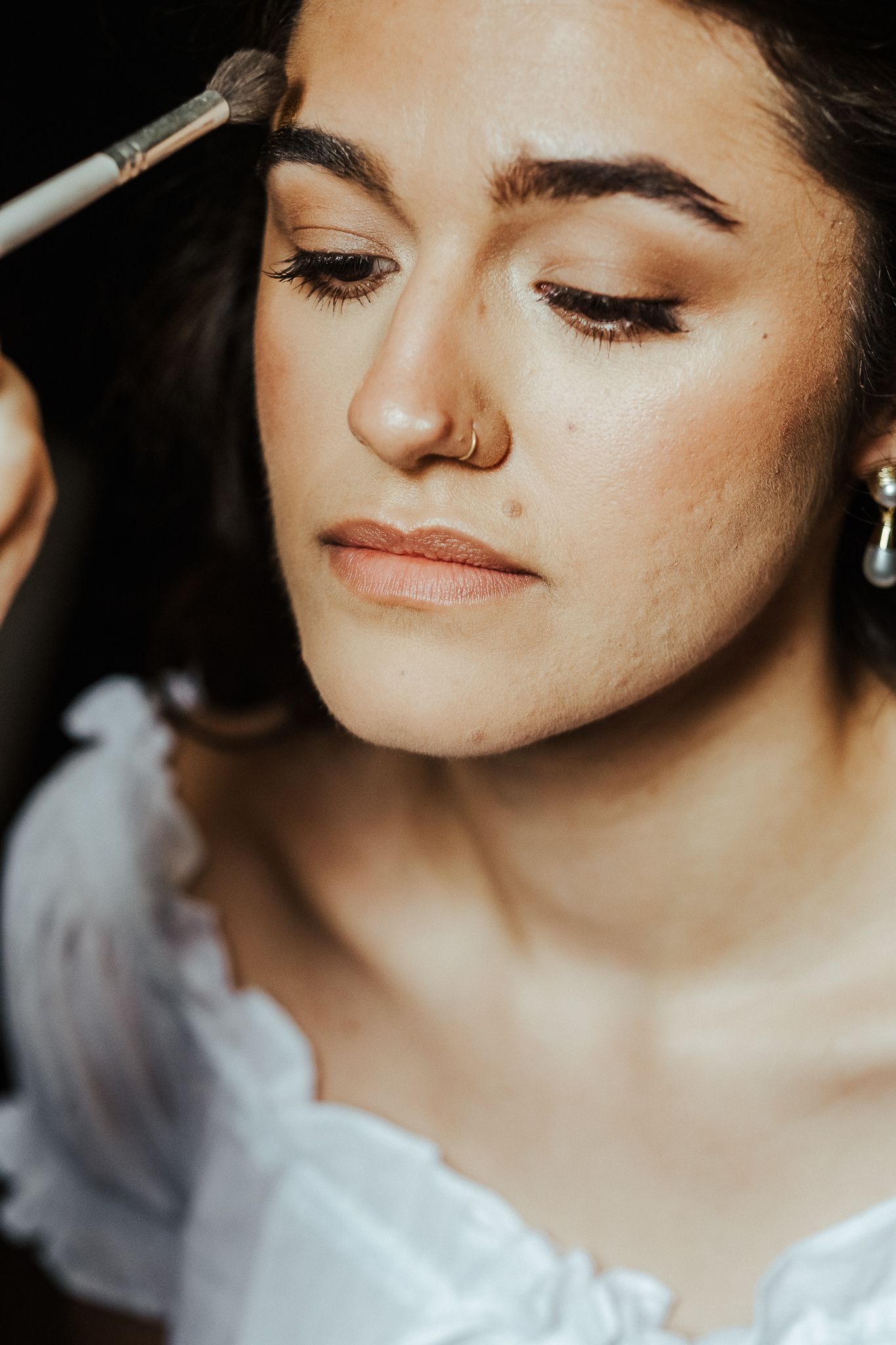 Soft focus beauty shot showing delicate makeup and natural light.