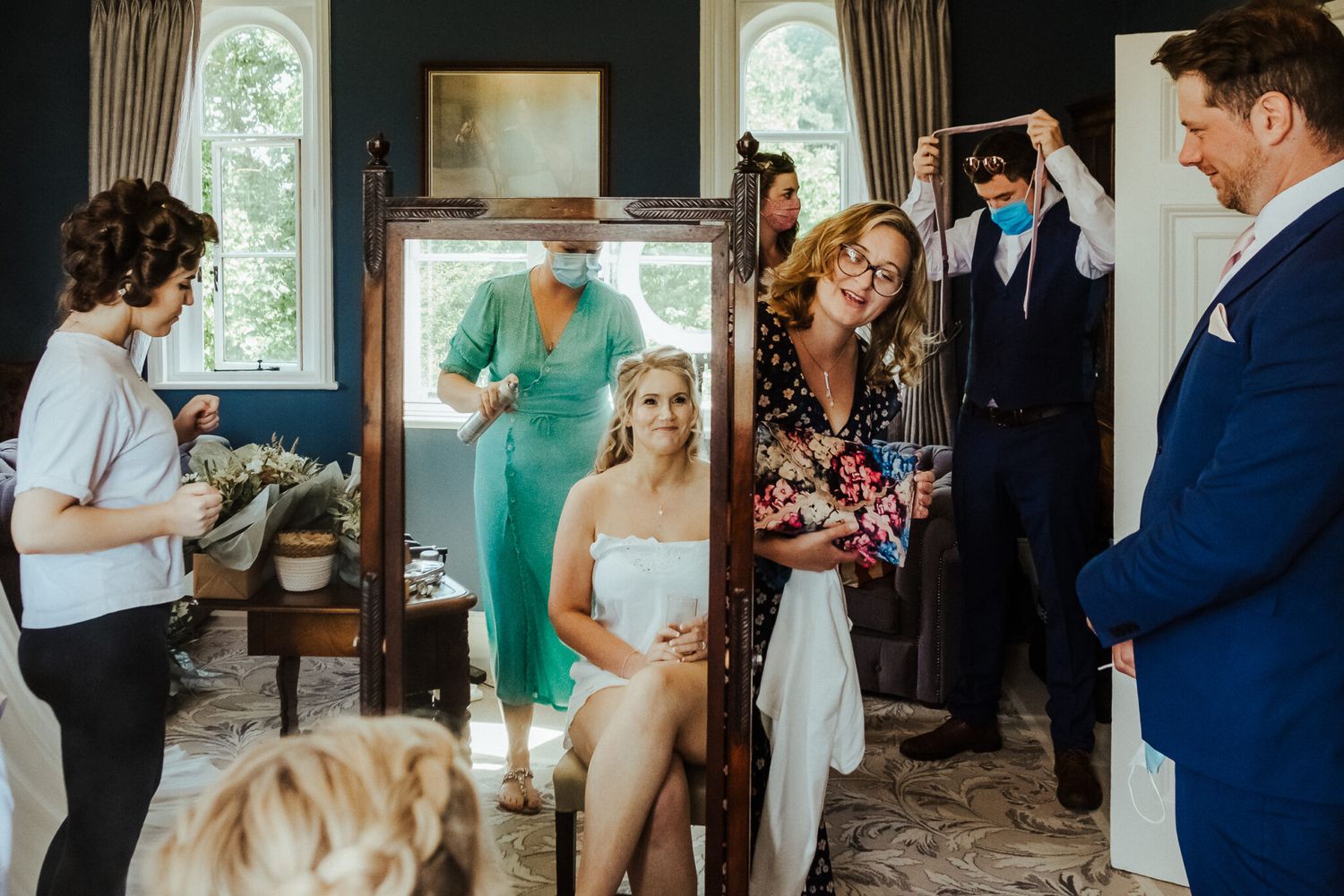 Preparations underway in a cozy room as a dog watches the pre-wedding activities.