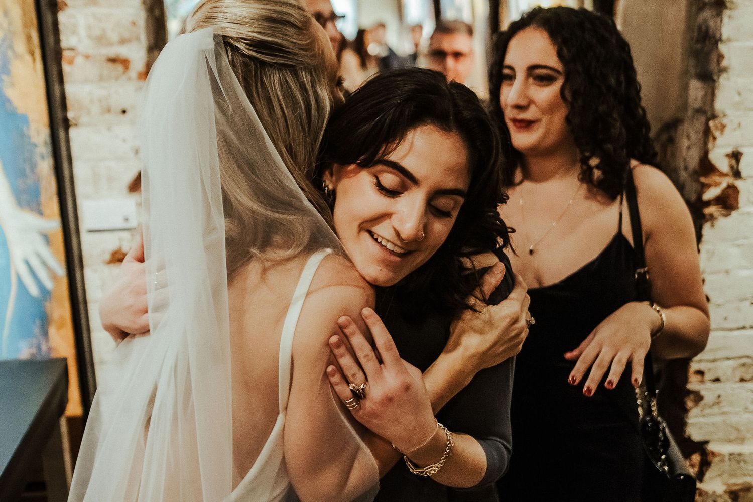 Emotional reactions during wedding celebrations in an industrial-chic venue.