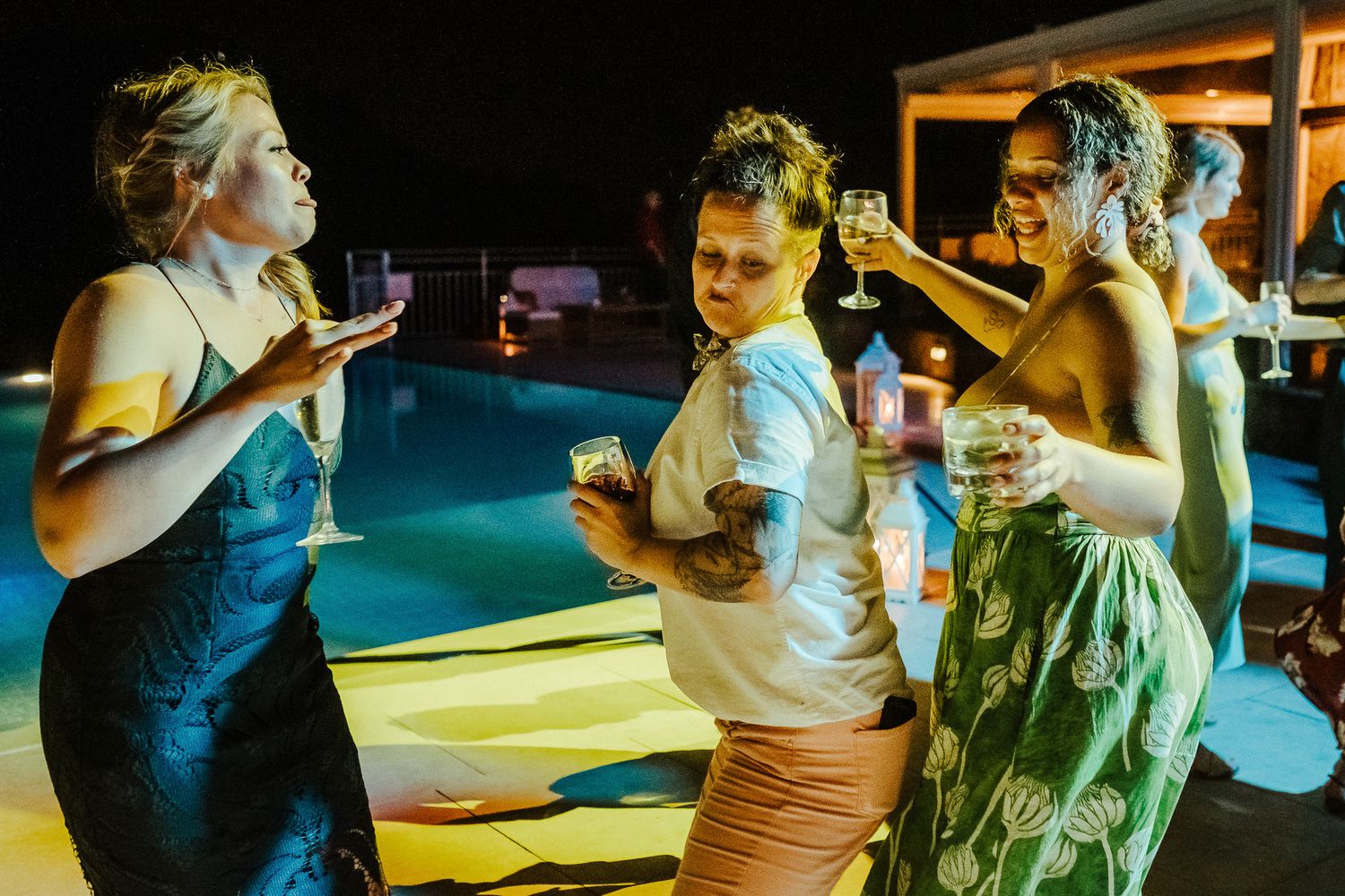Friends enjoying drinks and conversation at an outdoor nighttime party.