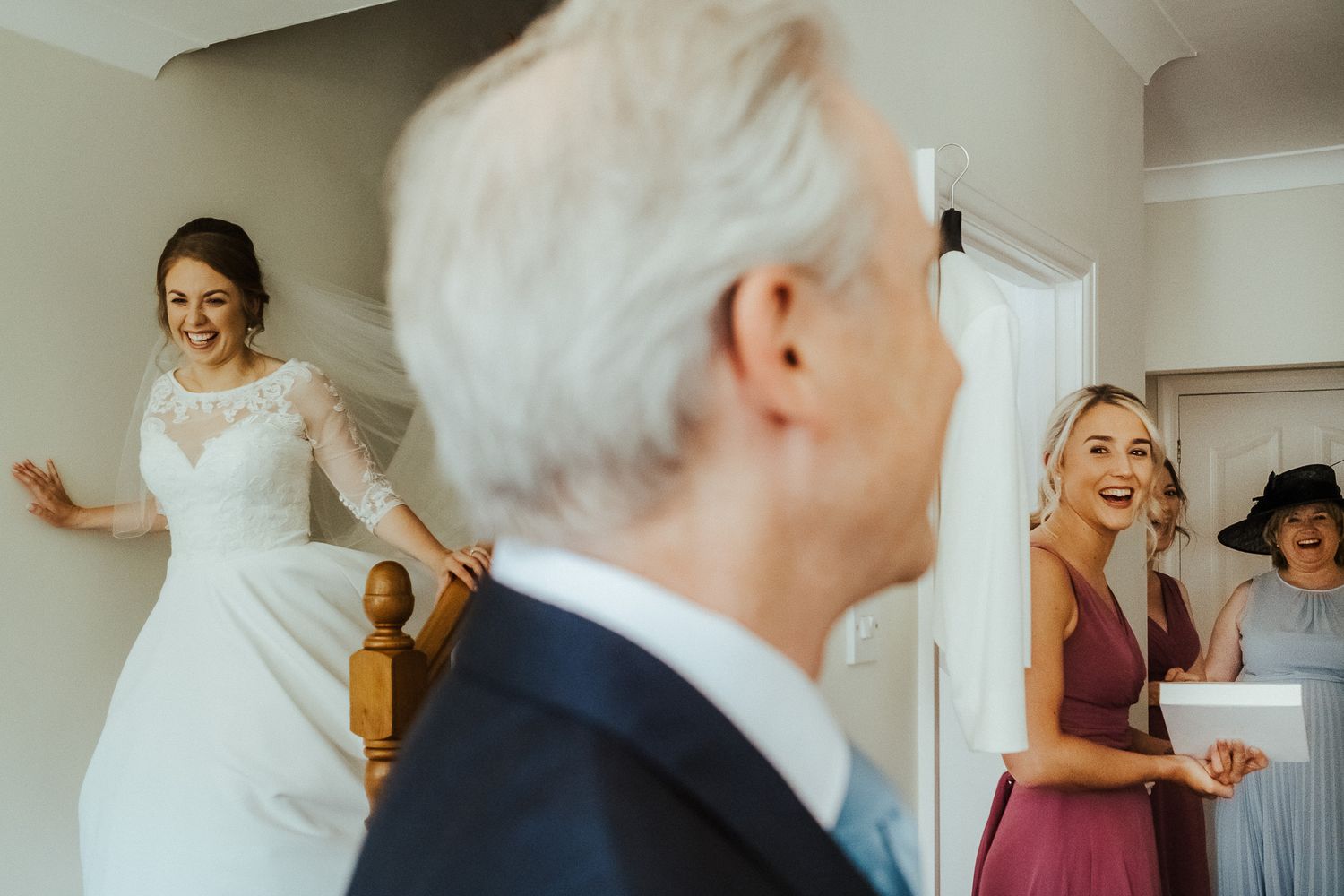 Getting ready scene with soft natural light streaming through windows during wedding preparations.