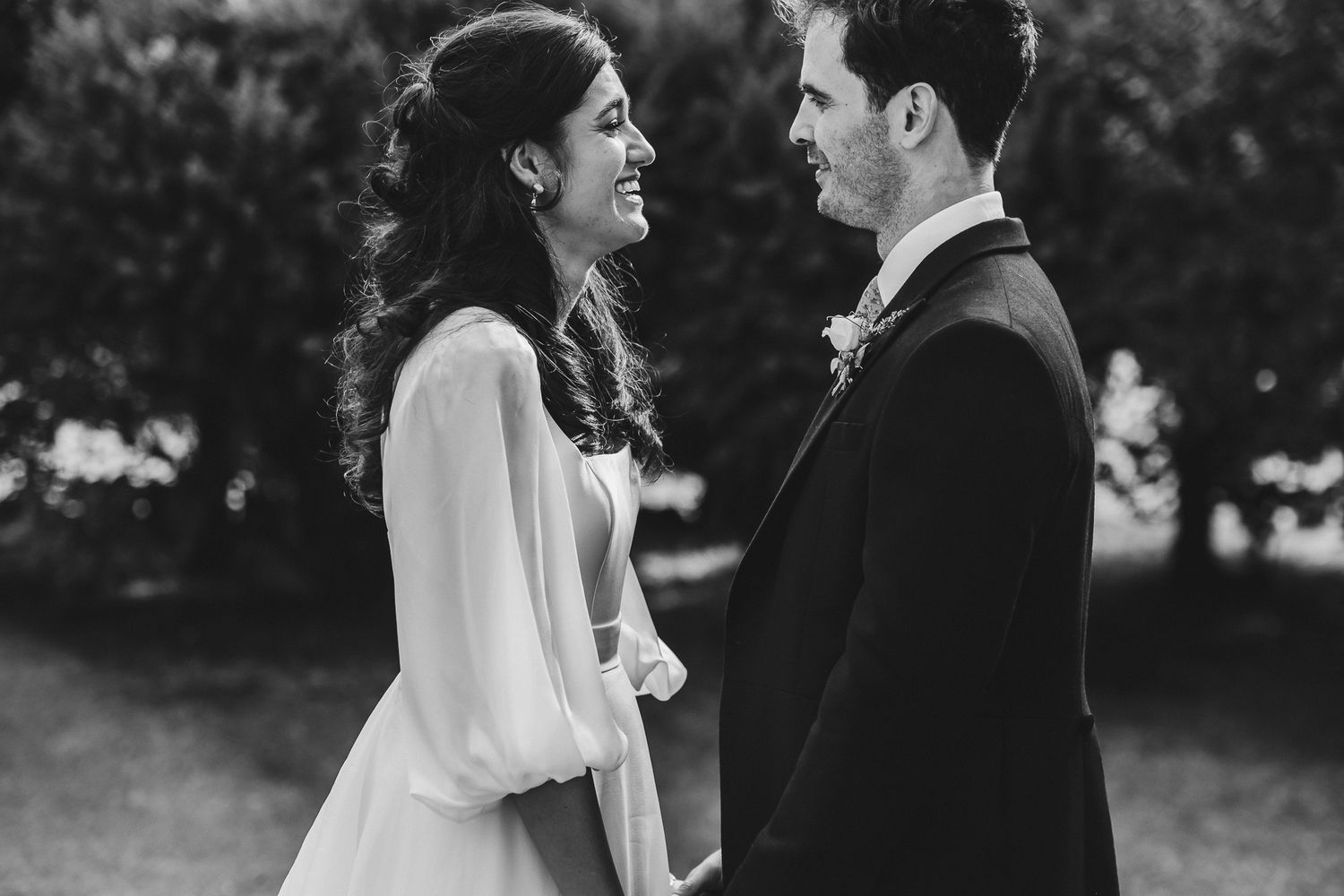 Black and white wedding portraits captured in a natural outdoor setting.