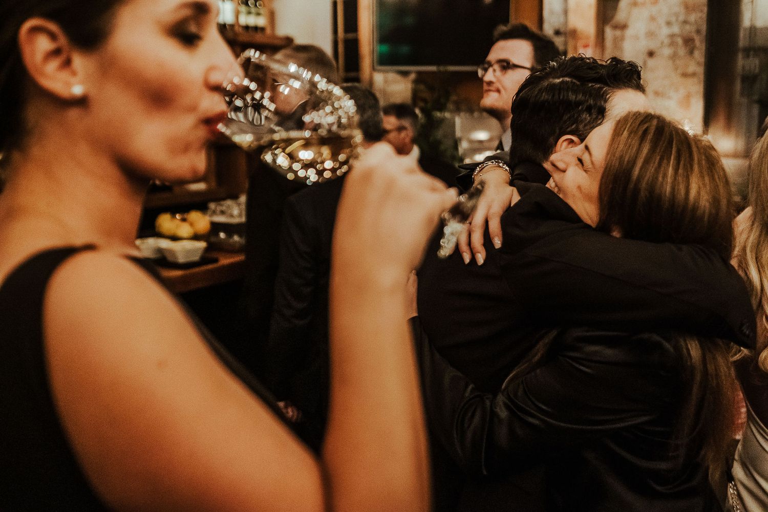 Friends share laughter and conversation during an intimate evening gathering.