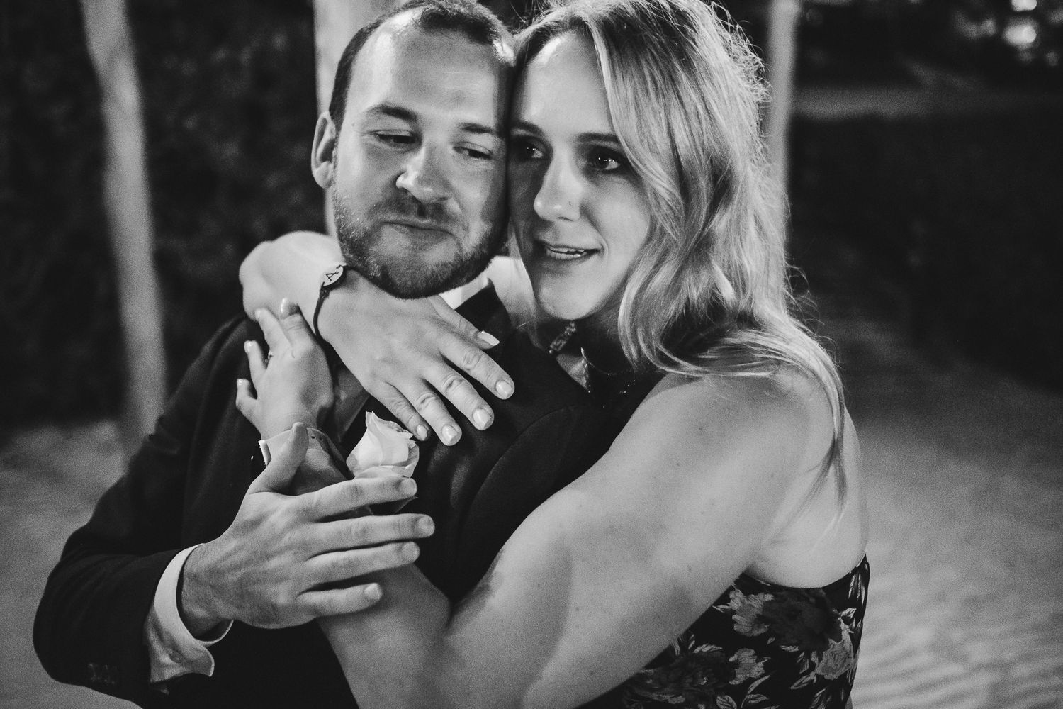 A tender moment between a couple during an evening celebration.