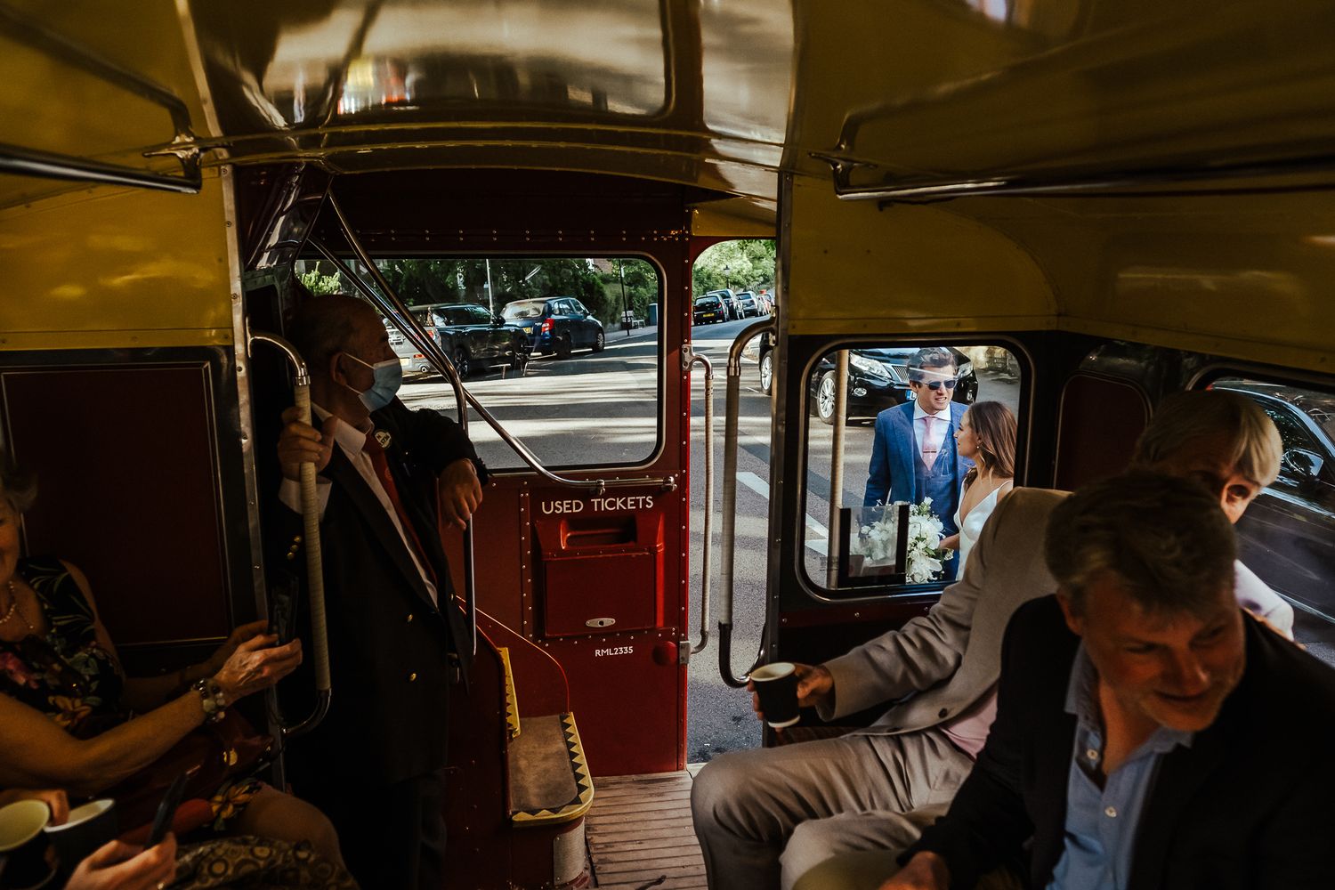 Interior view of passengers riding in a vintage double-decker bus.