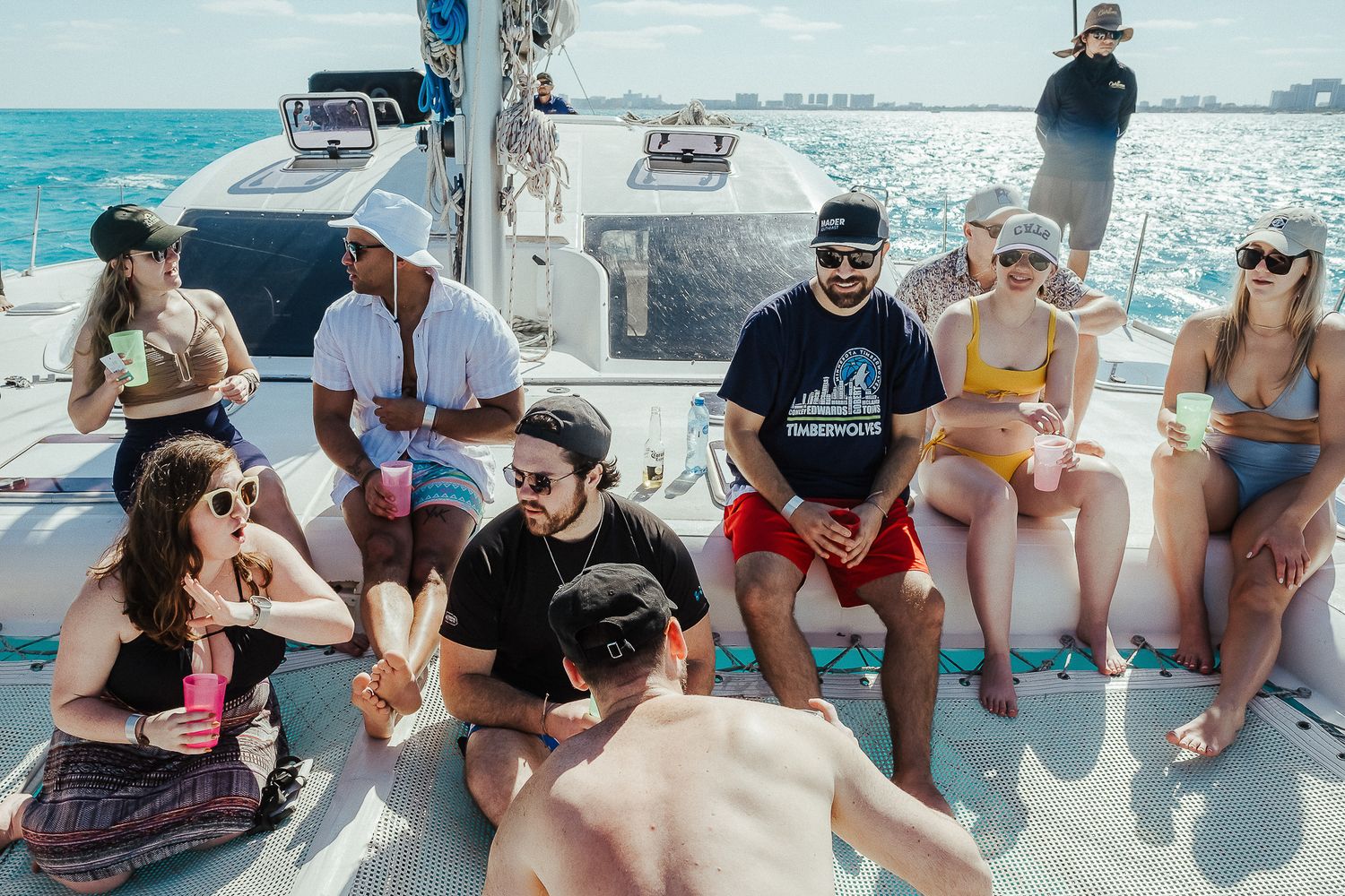 People lounging on a boat deck during a sunny day cruise.