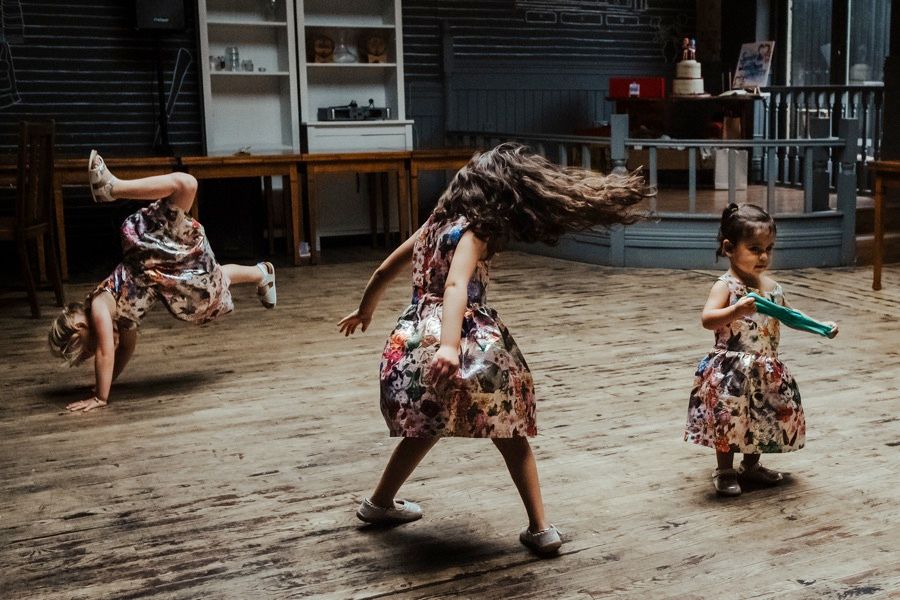 Dynamic dance floor scene with people in patterned dresses creating movement.
