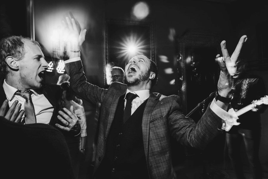 Black and white photos of guests enjoying a lively wedding reception dance party.