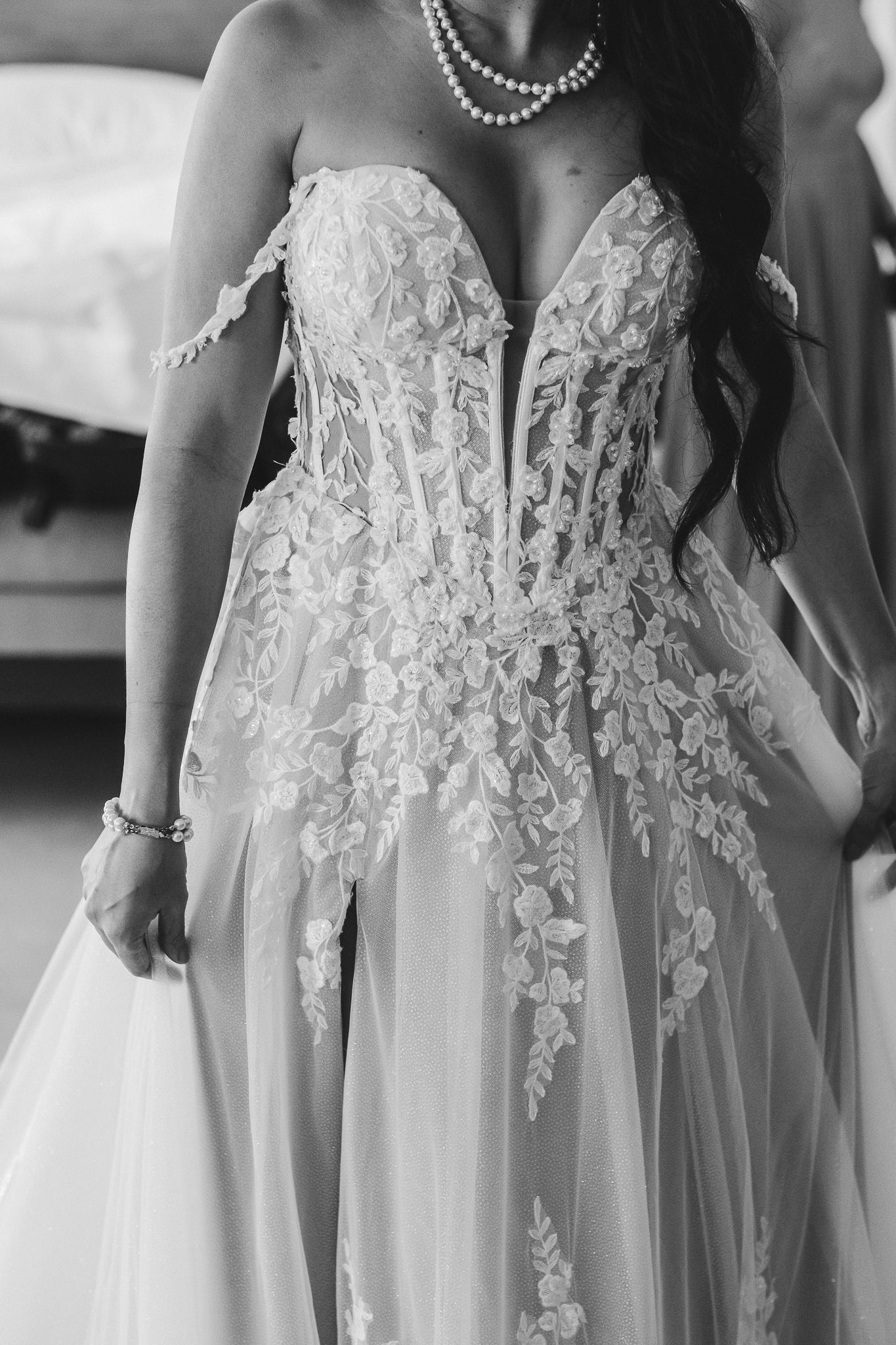Close up of intricate lace detailing on a strapless wedding gown bodice.