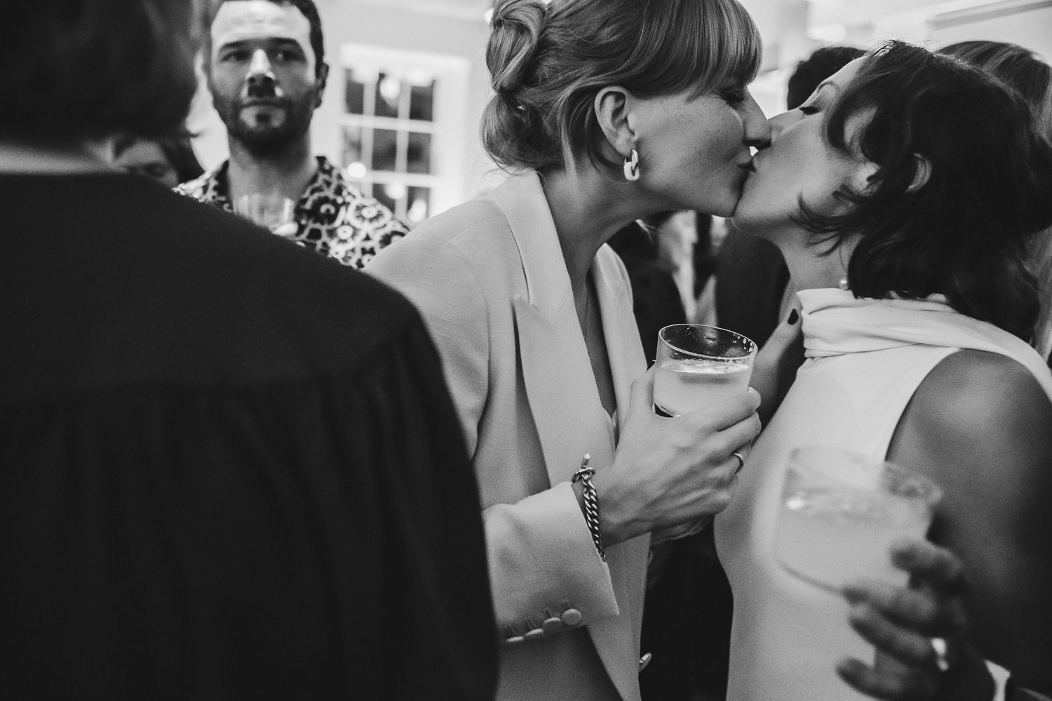 Intimate moment between two people at a celebratory event.