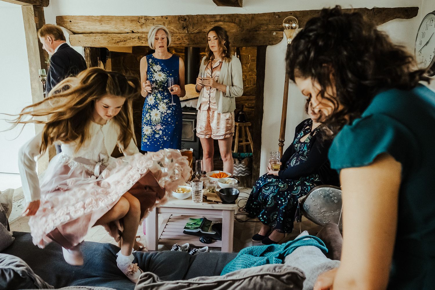 Wedding preparation scene with people getting ready in rustic room.