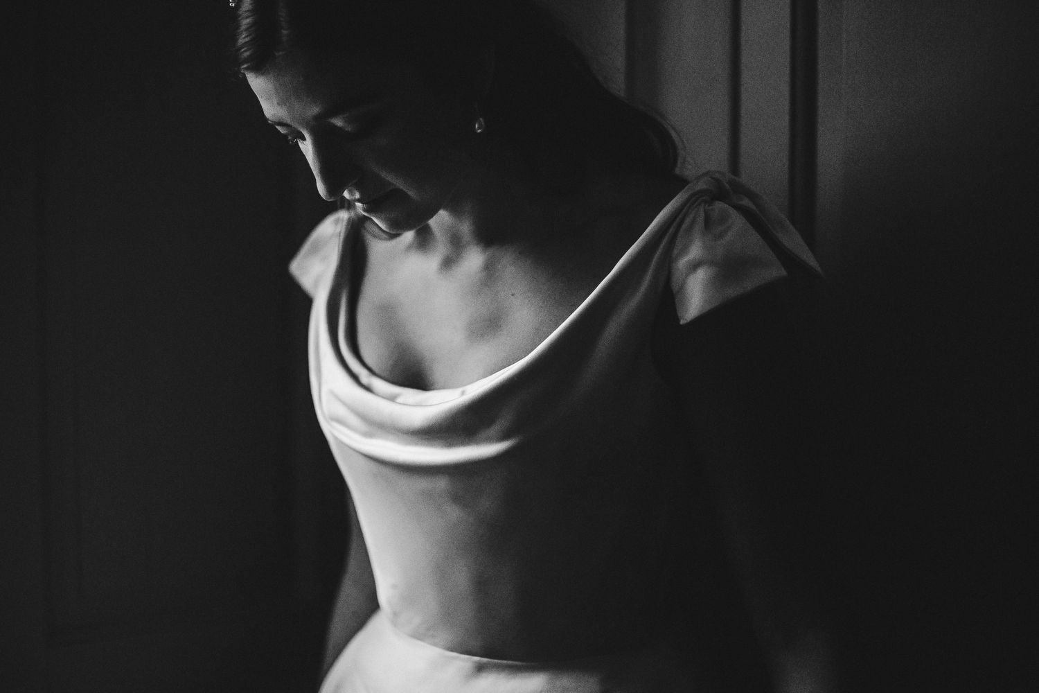 Close-up detail of a cowl neck wedding dress in dramatic black and white.