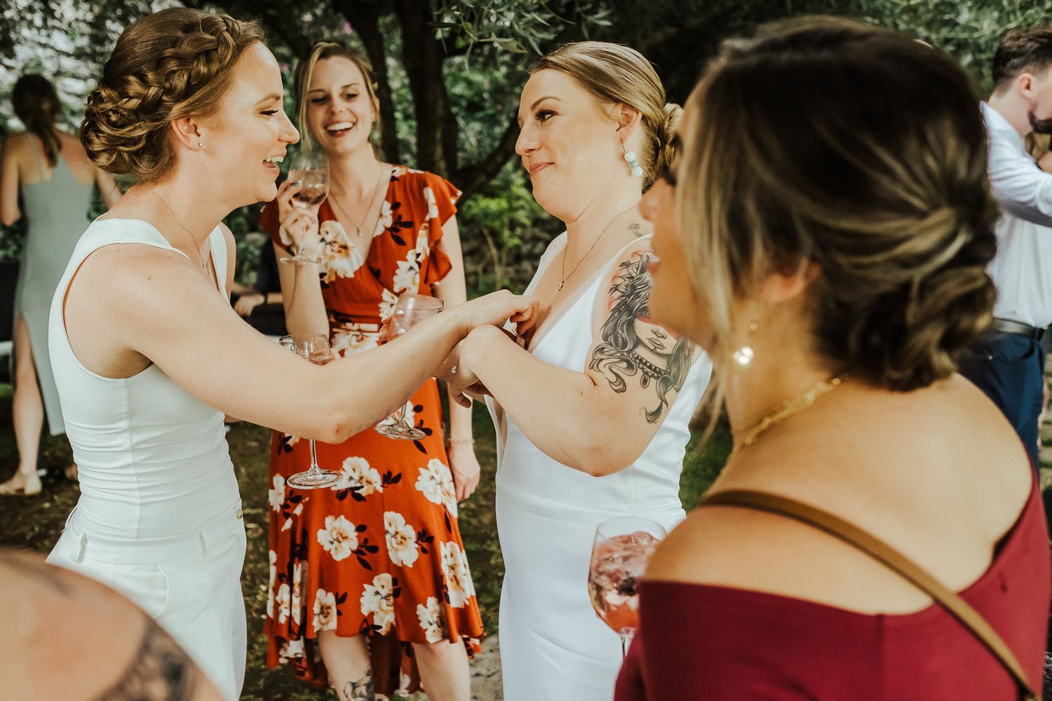 Wedding guests dancing and celebrating at an outdoor summer reception.