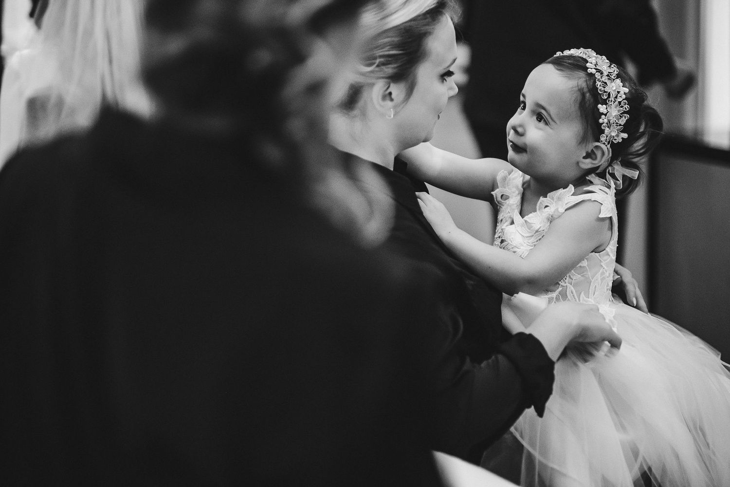 A tender moment captured in black and white during wedding preparations.