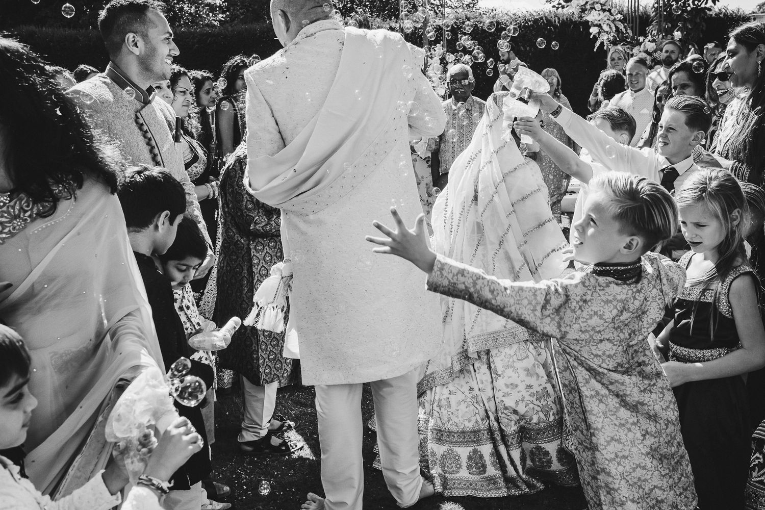 A group of wedding guests having fun dancing and celebrating together on the dance floor at a reception party.