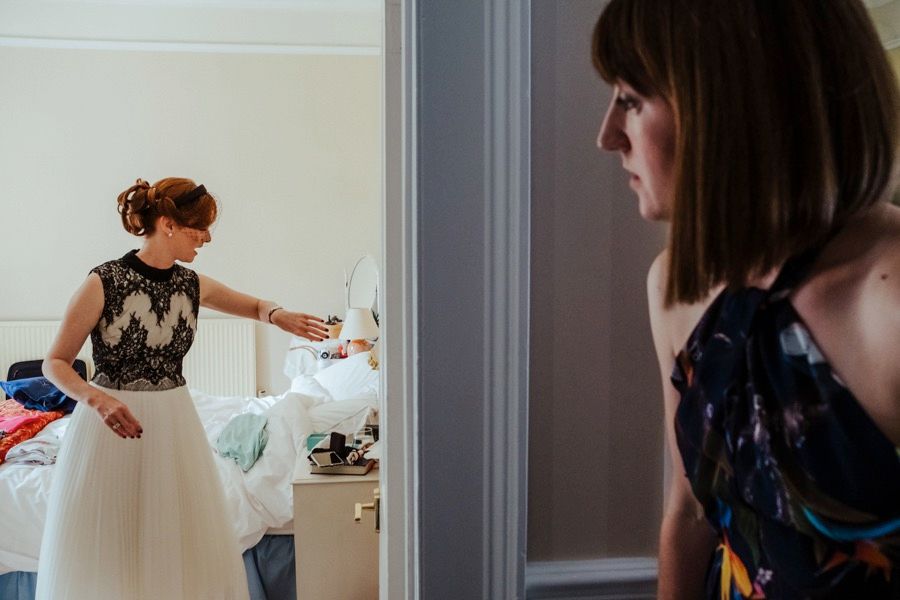 Getting ready moments captured through doorways and mirrors in soft natural light.