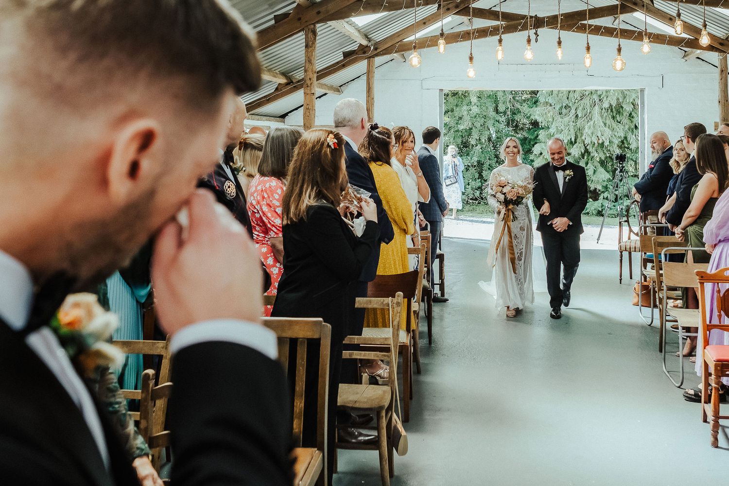 Modern barn-style wedding venue with exposed beams and natural lighting.