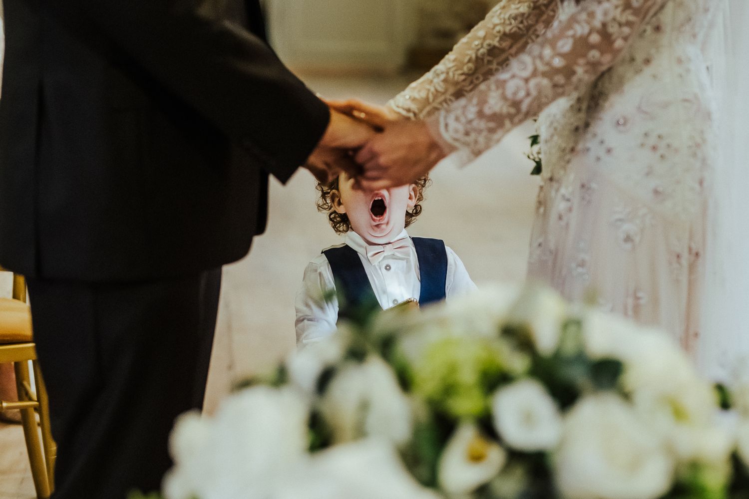 Elegant wedding ceremony details with white floral arrangements and delicate decor elements.
