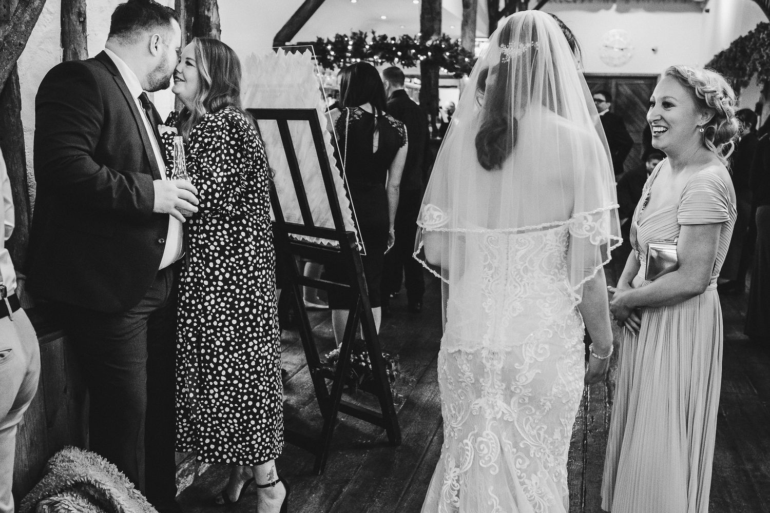 Wedding party members share candid moments during the celebration.