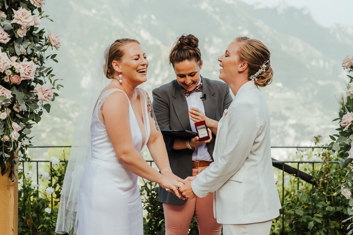 A heartfelt moment shared during an outdoor wedding ceremony with mountains in the background.