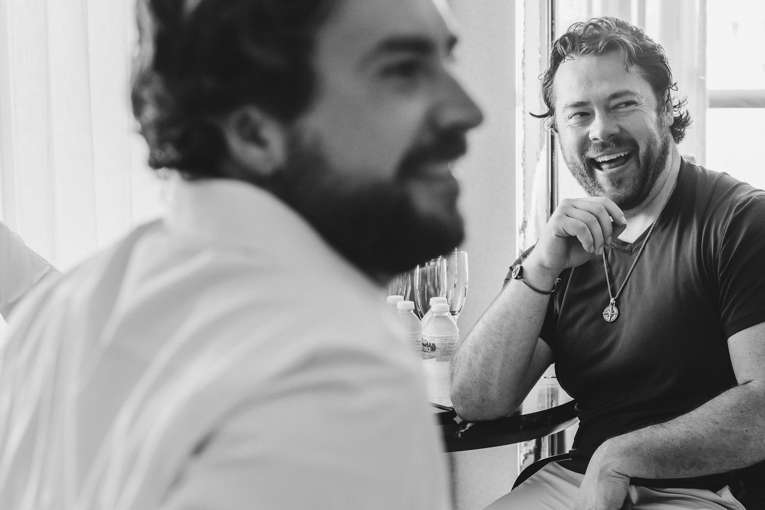 Two people engaged in animated conversation in a black and white candid photo.