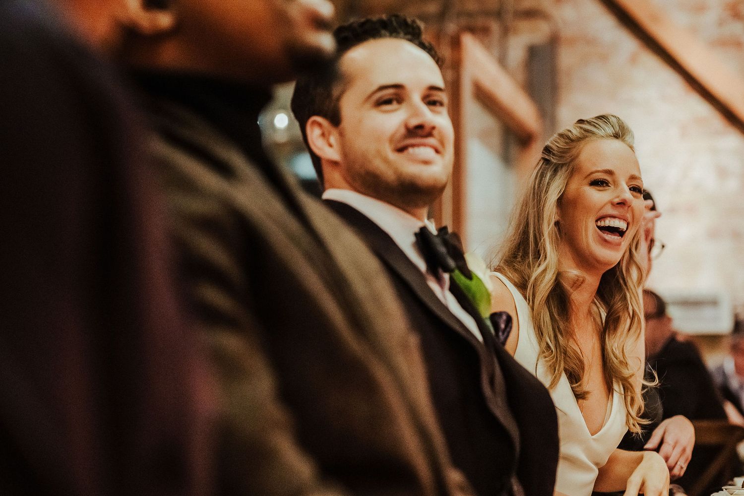 Candid moments captured during an elegant evening celebration with warm lighting.