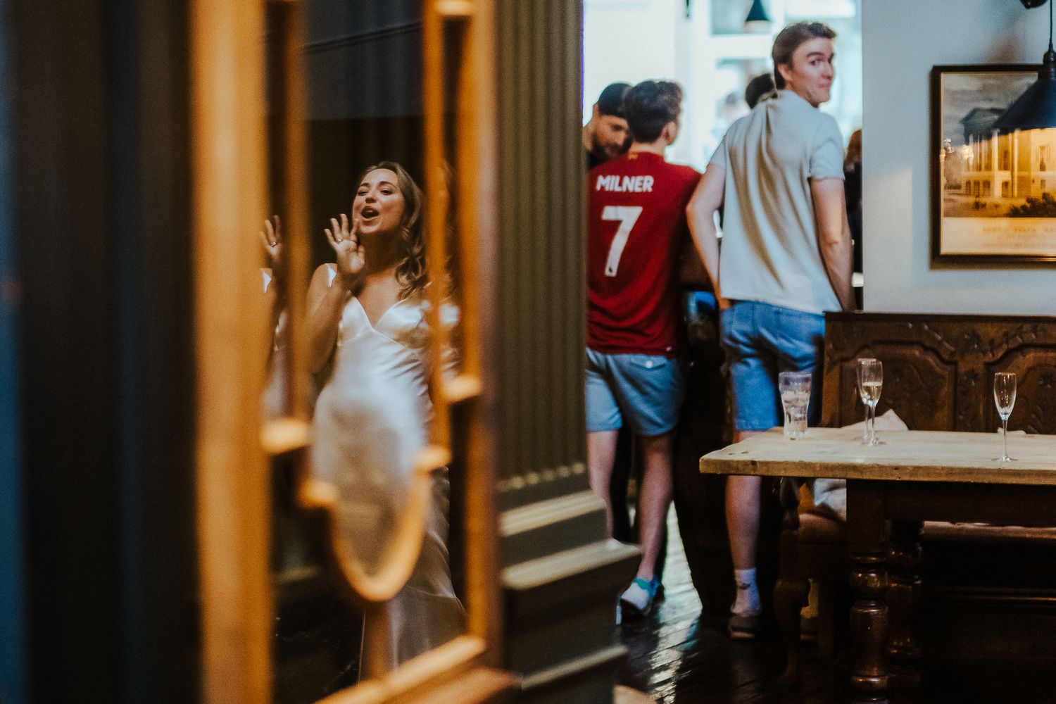 Candid moments captured in warm-toned indoor lighting at an event.