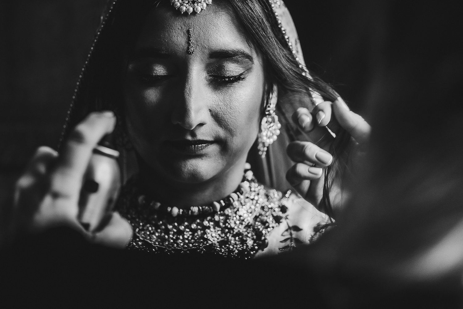 Artistic black and white close-up shots of wedding jewelry and decorative details.