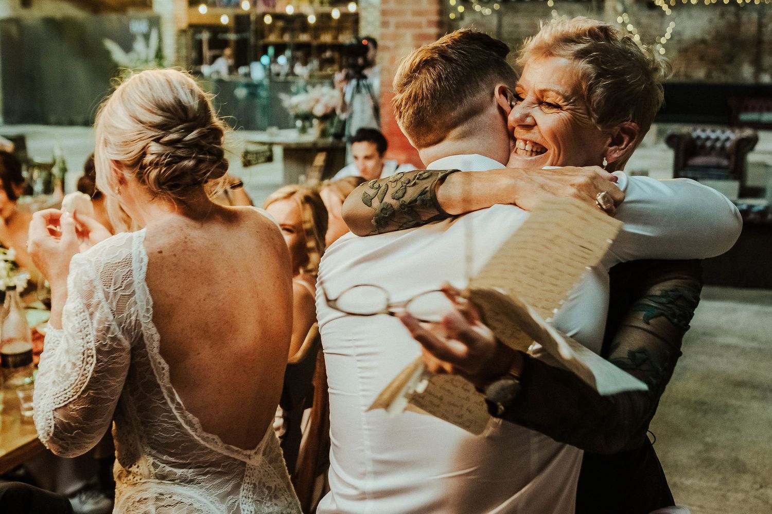 Candid moments of celebration captured during wedding reception.