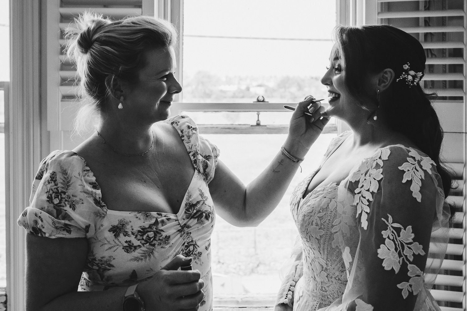 Wedding morning preparation scene with natural window lighting.