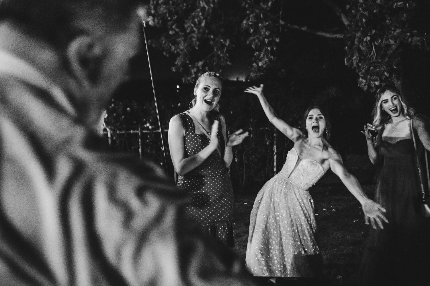 Wedding guests dance joyfully during reception party celebration.