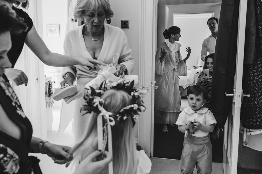 Wedding morning preparations captured in a series of candid black and white getting ready moments.