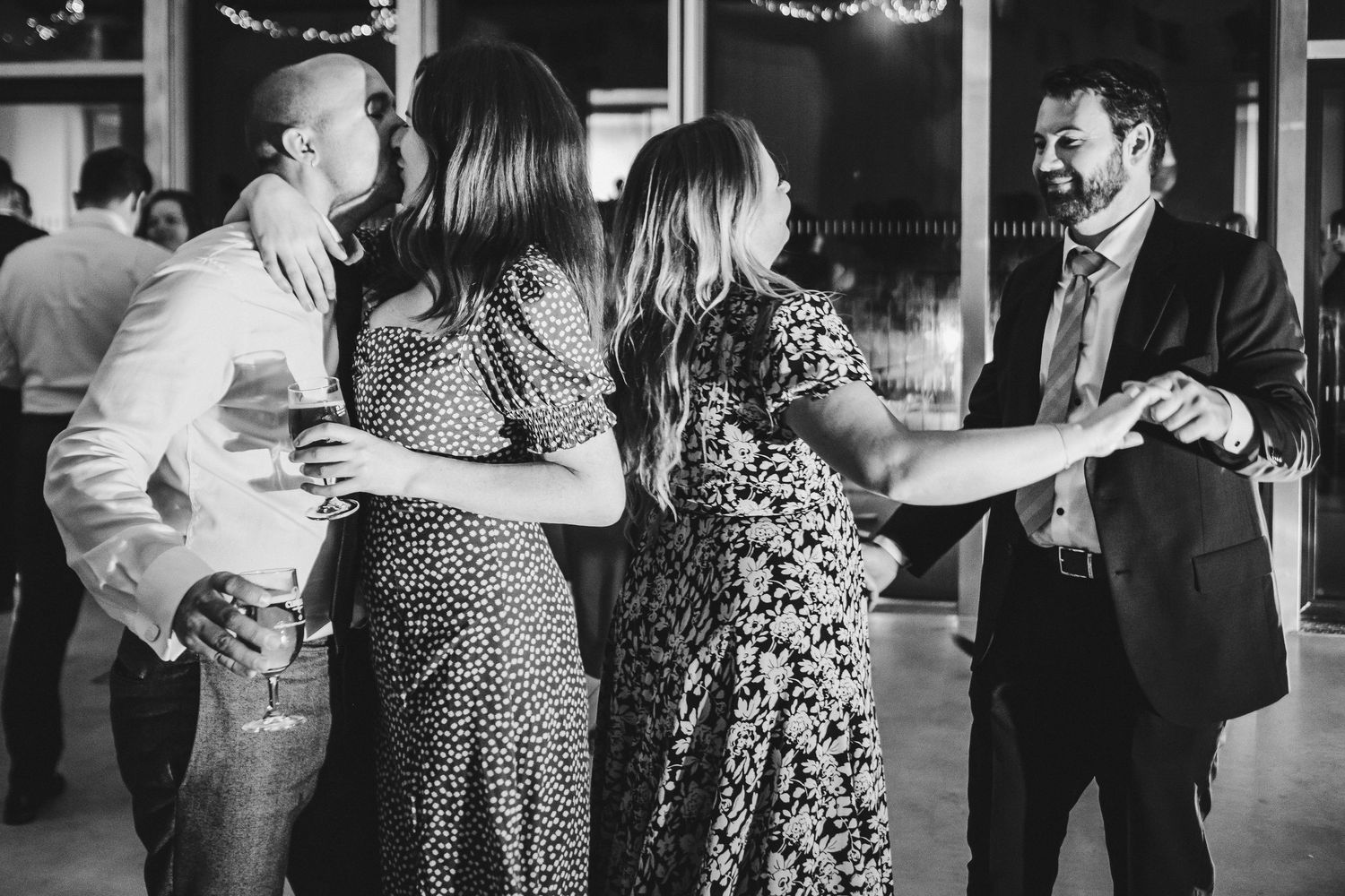 Couples dancing together at formal event in black and white photography.