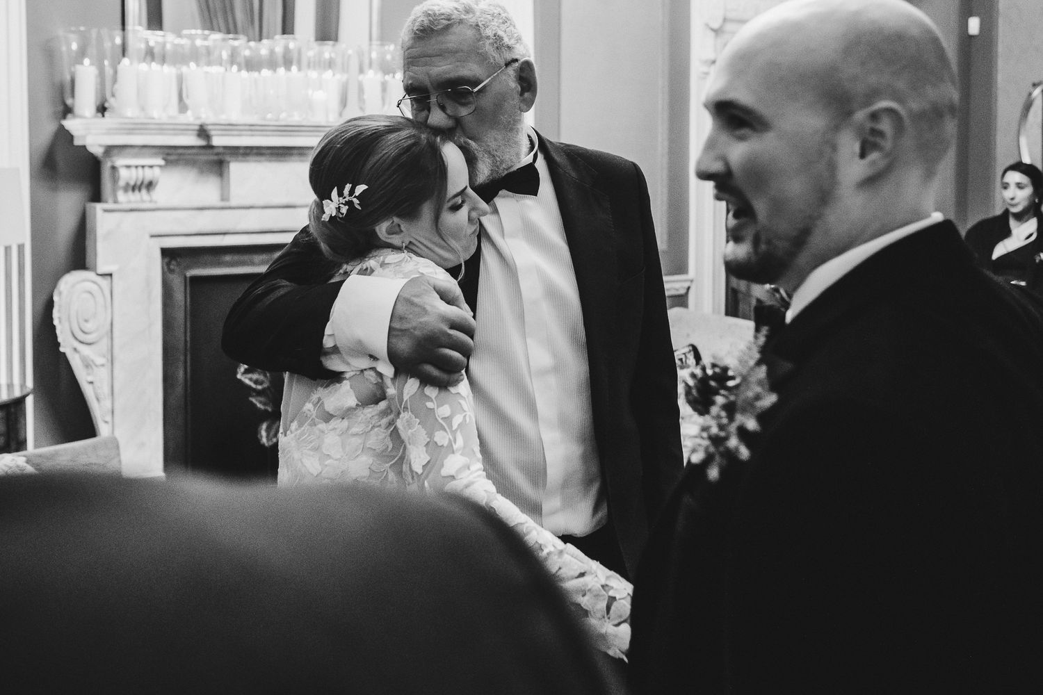 Black and white candid shots of wedding celebration moments in an elegant venue.