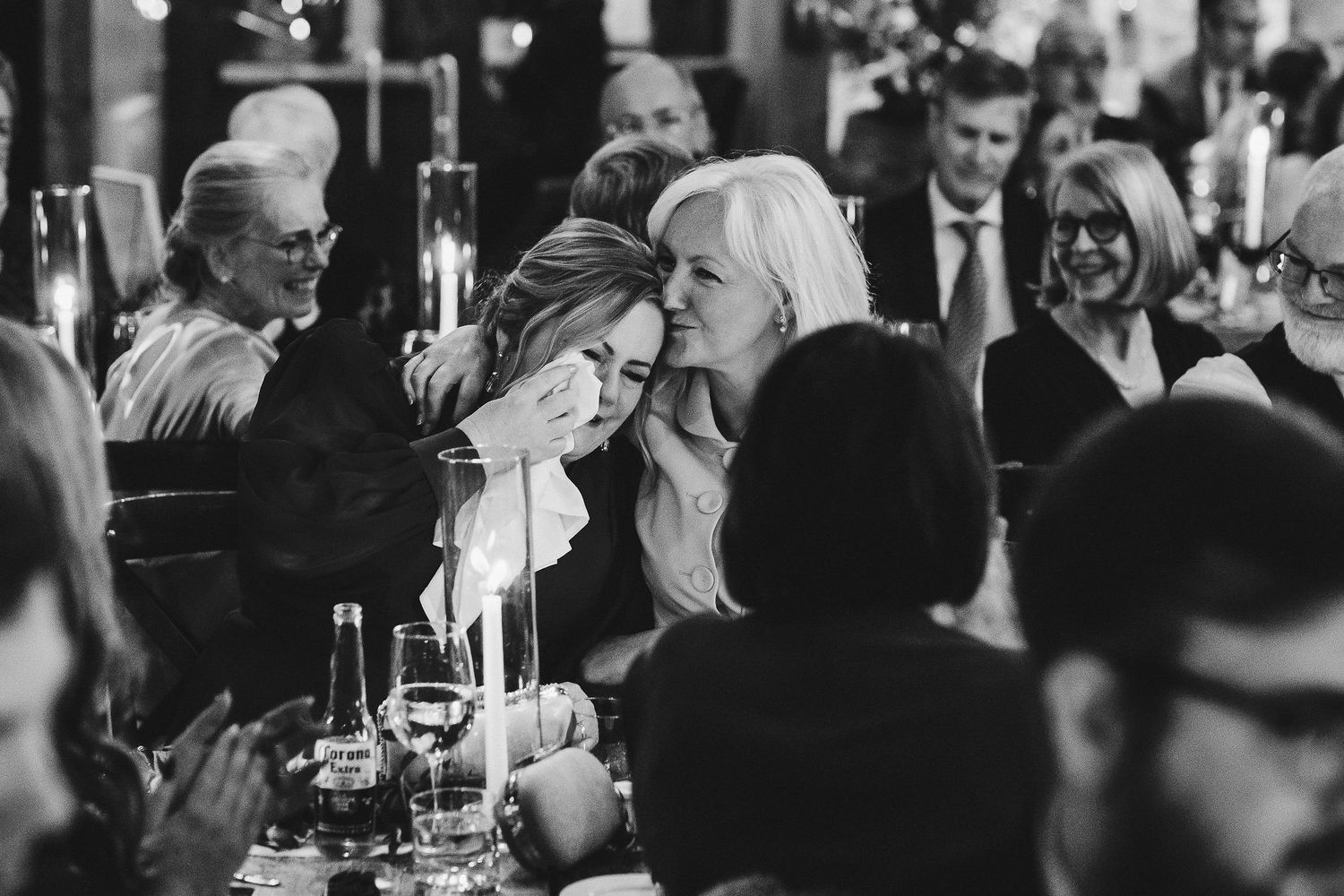 Party guests gathered around tables at an elegant evening reception.